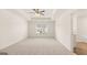 Spacious bedroom with a tray ceiling, ceiling fan, carpet, and a window with blinds at 325 Silver Moon Dr, Loganville, GA 30052