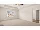 Spacious bedroom with a tray ceiling, ceiling fan, carpet, and a window with blinds at 325 Silver Moon Dr, Loganville, GA 30052