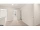 Upstairs hallway with carpet, multiple doorways, and neutral wall paint at 325 Silver Moon Dr, Loganville, GA 30052