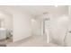 Upstairs hallway featuring a nearby bathroom with tile floor and a linen closet at 325 Silver Moon Dr, Loganville, GA 30052