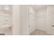 Hallway with neutral walls and carpet that leads to a walk-in closet at 325 Silver Moon Dr, Loganville, GA 30052