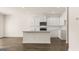 Modern kitchen with white cabinets, stainless steel microwave, and hardwood flooring at 325 Silver Moon Dr, Loganville, GA 30052