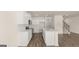 Modern kitchen with white cabinets, island with sink, and hardwood flooring at 325 Silver Moon Dr, Loganville, GA 30052
