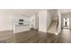 Open-concept kitchen featuring white cabinets, a center island, stainless appliances, and hardwood flooring at 325 Silver Moon Dr, Loganville, GA 30052