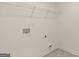 Neutral laundry room with shelving, outlets, and water hookups at 325 Silver Moon Dr, Loganville, GA 30052
