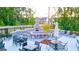 Outdoor grilling area with a stone fireplace, seating, and dining spaces for community gatherings at 325 Silver Moon Dr, Loganville, GA 30052