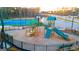 A playground area complete with slides, climbing structures, and tennis courts in the background at 325 Silver Moon Dr, Loganville, GA 30052