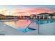 Community pool with fun water features and lounge seating in the evening light at 325 Silver Moon Dr, Loganville, GA 30052