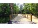 Scenic walking trail with wooden bridge amidst lush greenery, offering a peaceful outdoor experience at 325 Silver Moon Dr, Loganville, GA 30052
