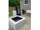 Close-up of the back patio with a prominent fire pit, seating, and adjacent yard at 785 Ne South Pine St, Conyers, GA 30012