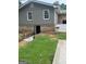 Backyard view showcasing a walkout basement entrance, and lush lawn at 785 Ne South Pine St, Conyers, GA 30012