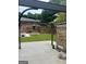 Backyard view with a partially covered patio, stone wall, and landscaped yard at 785 Ne South Pine St, Conyers, GA 30012
