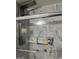 Modern bathroom with marble tile walls and a glass-enclosed bathtub at 785 Ne South Pine St, Conyers, GA 30012