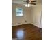 Bright bedroom with hardwood floors, ceiling fan, and natural light at 785 Ne South Pine St, Conyers, GA 30012