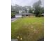 Traditional brick home with a well-manicured lawn, attached garage, and mature trees, perfect for Gathering life at 785 Ne South Pine St, Conyers, GA 30012
