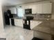 Modern kitchen featuring white cabinets, black appliances, and granite countertops, perfect for cooking and entertaining at 785 Ne South Pine St, Conyers, GA 30012