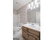 Bathroom featuring a single vanity, mirror, and tub/shower combo at 19 Indian Bluff Dr, Sharpsburg, GA 30277
