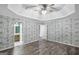 Bright bedroom with trey ceiling, ceiling fan, hardwood floors, and ensuite bathroom at 19 Indian Bluff Dr, Sharpsburg, GA 30277