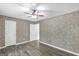 Bedroom features two doors, hardwood floors, and a ceiling fan at 19 Indian Bluff Dr, Sharpsburg, GA 30277