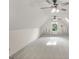 Spacious bonus room features vaulted ceilings, ceiling fans and a window with flower decals on the wall at 19 Indian Bluff Dr, Sharpsburg, GA 30277