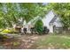 Side view of a white house showcasing well-maintained landscaping and mature trees at 19 Indian Bluff Dr, Sharpsburg, GA 30277