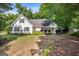 Charming white home with a manicured lawn, complemented by a bright green front door at 19 Indian Bluff Dr, Sharpsburg, GA 30277