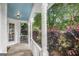 Covered porch with white railings, offering a peaceful view of the surrounding trees and greenery at 19 Indian Bluff Dr, Sharpsburg, GA 30277