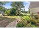 Landscaped front yard featuring colorful flowers and greenery along a walkway at 19 Indian Bluff Dr, Sharpsburg, GA 30277