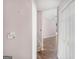 Hallway with wood floors and a closet, leading to stairs and a bright living space at 19 Indian Bluff Dr, Sharpsburg, GA 30277