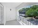 View from the balcony of the property featuring a paved driveway and mature trees at 5490 Chemin De Vie, Sandy Springs, GA 30342