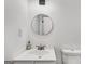 A bathroom features a white sink, round mirror, and toilet at 5490 Chemin De Vie, Sandy Springs, GA 30342