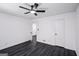 A bedroom features a ceiling fan, hardwood floors, and white walls at 5490 Chemin De Vie, Sandy Springs, GA 30342