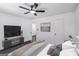 Spacious bedroom with modern decor, featuring a ceiling fan and television at 5490 Chemin De Vie, Sandy Springs, GA 30342