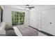Cozy bedroom featuring a window view and lots of closet space at 5490 Chemin De Vie, Sandy Springs, GA 30342