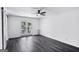 Bright bedroom with a ceiling fan, wood floors, and a door leading to the outside at 5490 Chemin De Vie, Sandy Springs, GA 30342