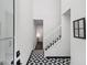 Bright foyer features stylish tile flooring and staircase at 5490 Chemin De Vie, Sandy Springs, GA 30342
