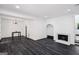 Bright living room with a modern fireplace and sleek dark flooring and simple modern furniture at 5490 Chemin De Vie, Sandy Springs, GA 30342