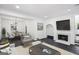 Inviting living room with fireplace, TV, contemporary furnishings, and a dining area with a table nearby at 5490 Chemin De Vie, Sandy Springs, GA 30342