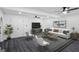 Cozy living room offers a white sofa, ceiling fans, a black and white rug, and a decorative indoor plant at 5490 Chemin De Vie, Sandy Springs, GA 30342