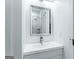 Bathroom with gray vanity and mirror showcasing tiled shower at 1835 Taylor Ave, East Point, GA 30344