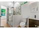 Bright bathroom featuring a glass enclosed shower, toilet, and vanity with modern fixtures at 1835 Taylor Ave, East Point, GA 30344