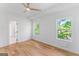 Bright bedroom with wood-look flooring, ceiling fan, and view of backyard at 1835 Taylor Ave, East Point, GA 30344