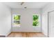 Sun-filled bedroom featuring wood-look floors and two windows with a backyard view at 1835 Taylor Ave, East Point, GA 30344