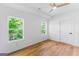 Sunlit bedroom with wood-look floors, ceiling fan, and white walls at 1835 Taylor Ave, East Point, GA 30344
