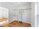 Empty walk-in closet featuring hardwood floors, built in shelving and clothes racks at 1835 Taylor Ave, East Point, GA 30344