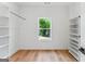 Large closet featuring hardwood floors, a bright window and open shelving at 1835 Taylor Ave, East Point, GA 30344