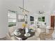 Virtual staging of the dining room. Dining space includes lots of natural light, and flows into the living room at 1835 Taylor Ave, East Point, GA 30344