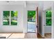 Bright entryway with hardwood floors, white walls, and a large window with a view of the front yard at 1835 Taylor Ave, East Point, GA 30344