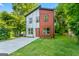 Charming two-story home features a modern design with a well-manicured lawn and a concrete driveway at 1835 Taylor Ave, East Point, GA 30344