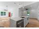 Bright kitchen with quartz island, stainless appliances, and open floor plan to living area at 1835 Taylor Ave, East Point, GA 30344